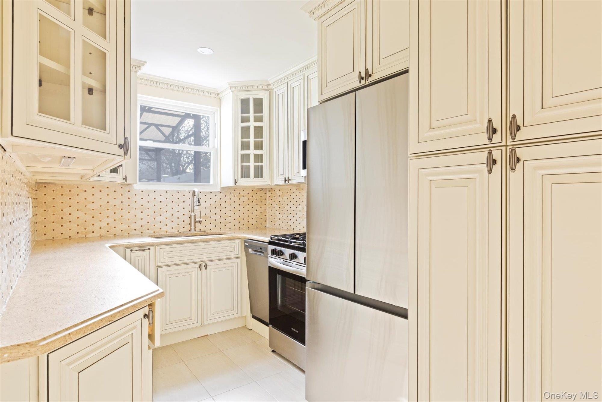 a kitchen with a refrigerator sink stove and cabinets