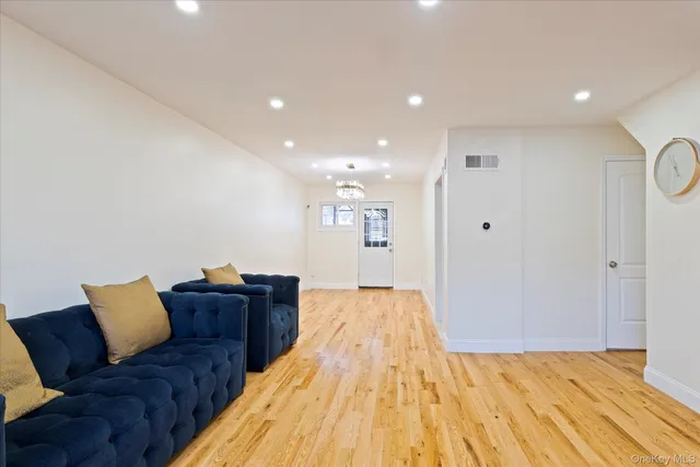 a view of a room with wooden floor and white walls