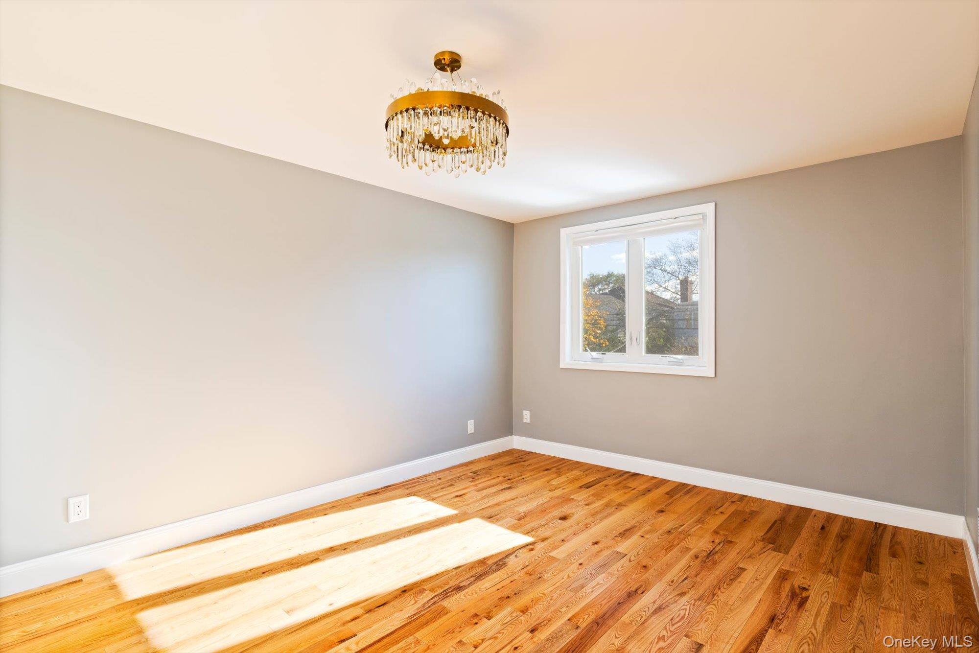 144-14 68th Avenue Queens, NY 11367 - Photo 5 of 15 a view of a room with wooden floor and white walls