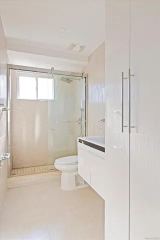 a bathroom with a toilet a sink and a mirror