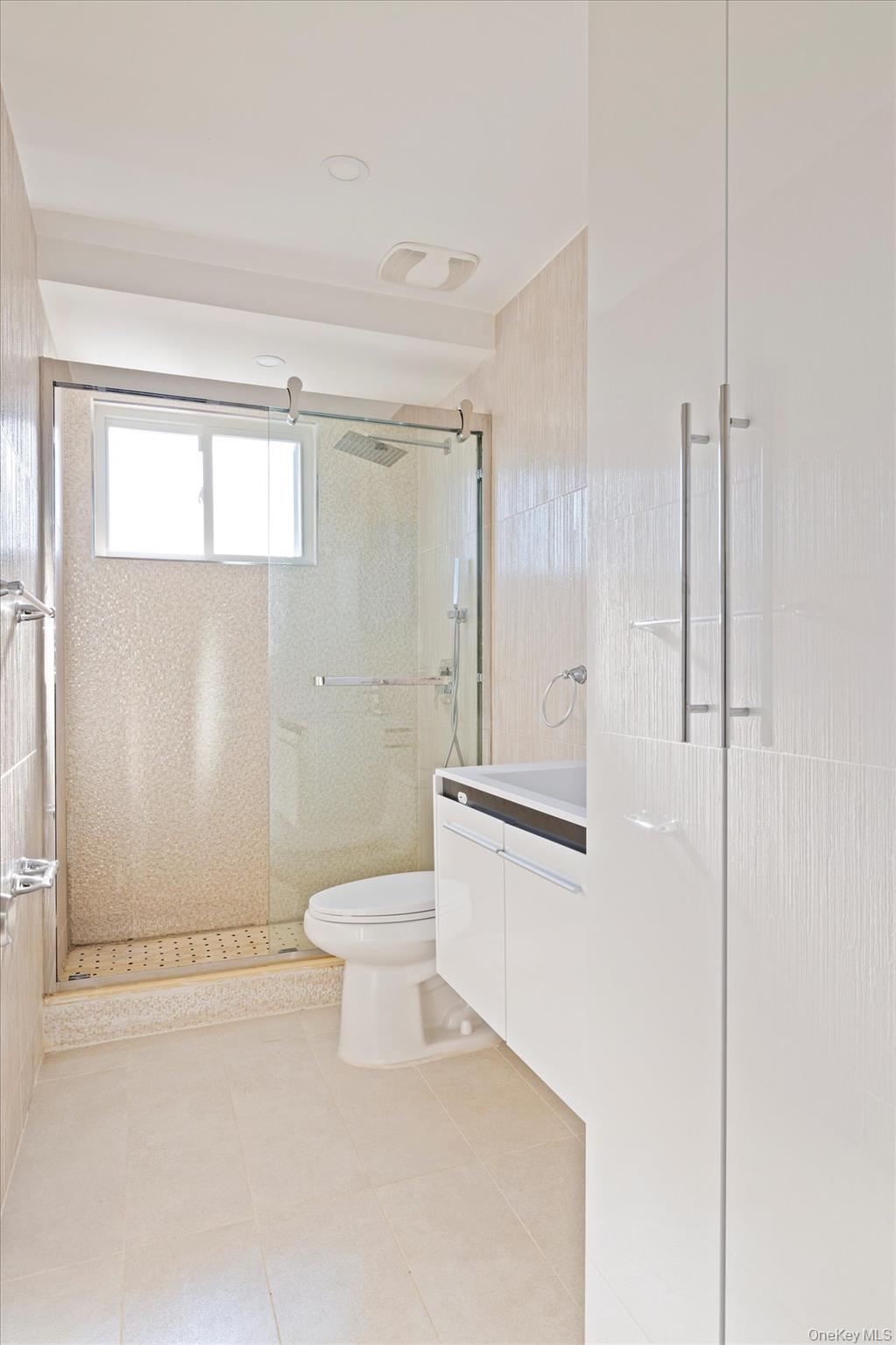 144-14 68th Avenue Queens, NY 11367 - Photo 9 of 15 a bathroom with a toilet a sink and shower