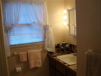 101 Depot Road, Unit 18 Chatham, MA 02633 - Photo 11 of 16 a bathroom with a granite countertop sink and white cabinets