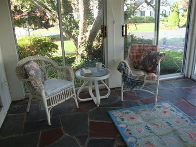 101 Depot Road, Unit 18 Chatham, MA 02633 - Photo 7 of 16 a view of a patio with table and chairs and potted plants