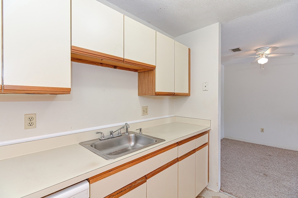 1811 Franklin Crossing Road, Unit 1811 Franklin, MA 02038 - Photo 15 of 31 a kitchen with stainless steel appliances granite countertop a sink and a white cabinets