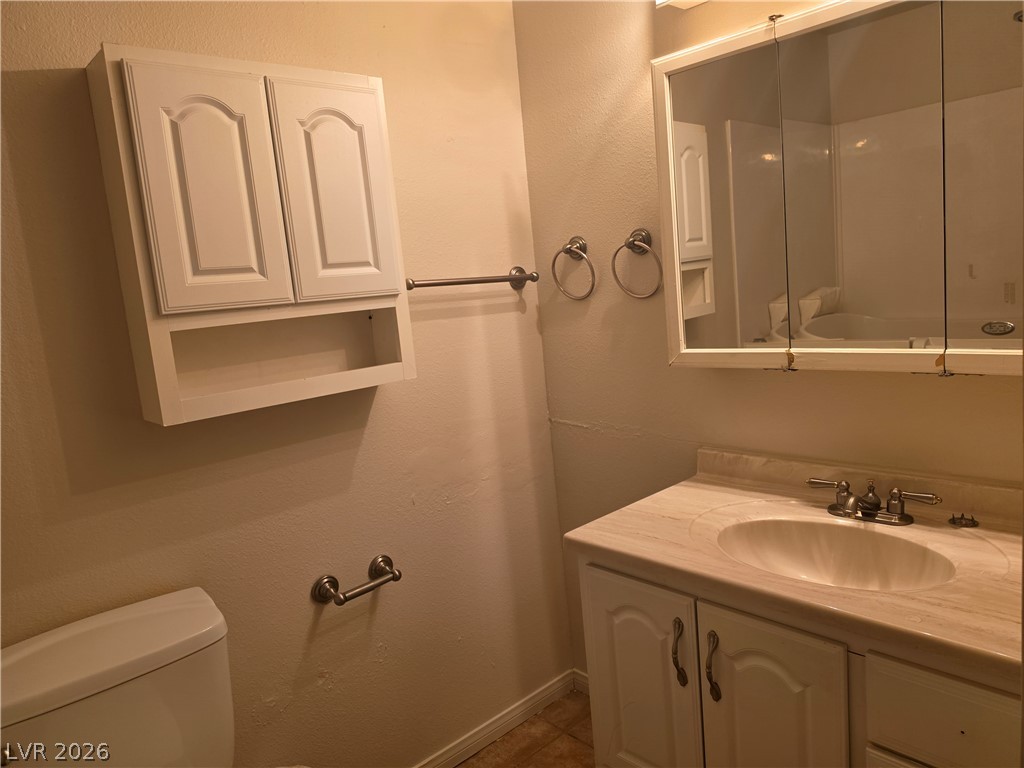 5289 Reeder Circle Las Vegas, NV 89119 - Photo 18 of 40 A classic vanity setup and wall cabinetry maximize storage in this functional bathroom.