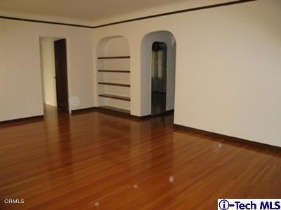 927 Atchison Street Pasadena, CA 91104 - Photo 3 of 13 an empty room with wooden floor and closet