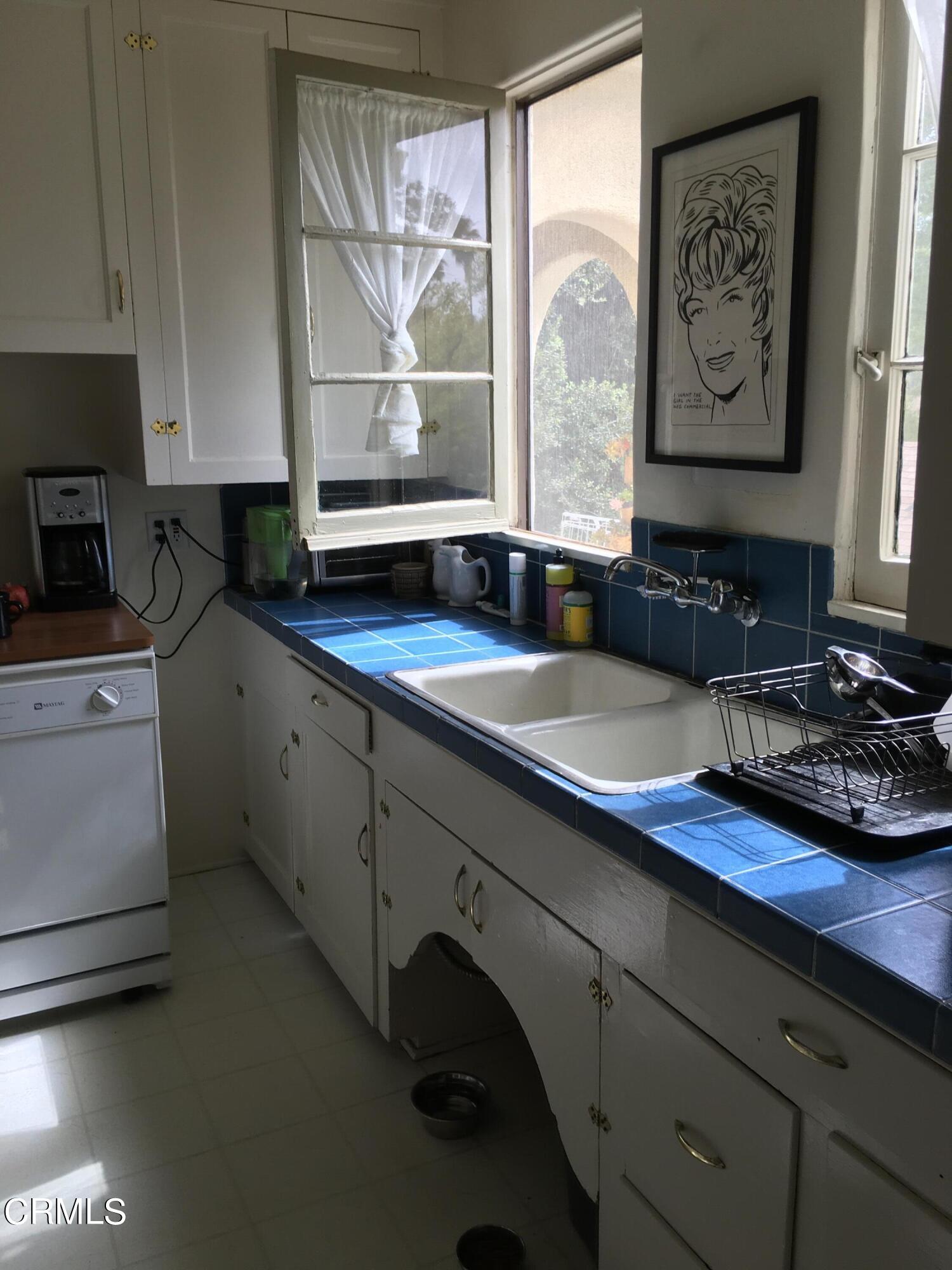 927 Atchison Street Pasadena, CA 91104 - Photo 5 of 13 a kitchen with sink a window and cabinets