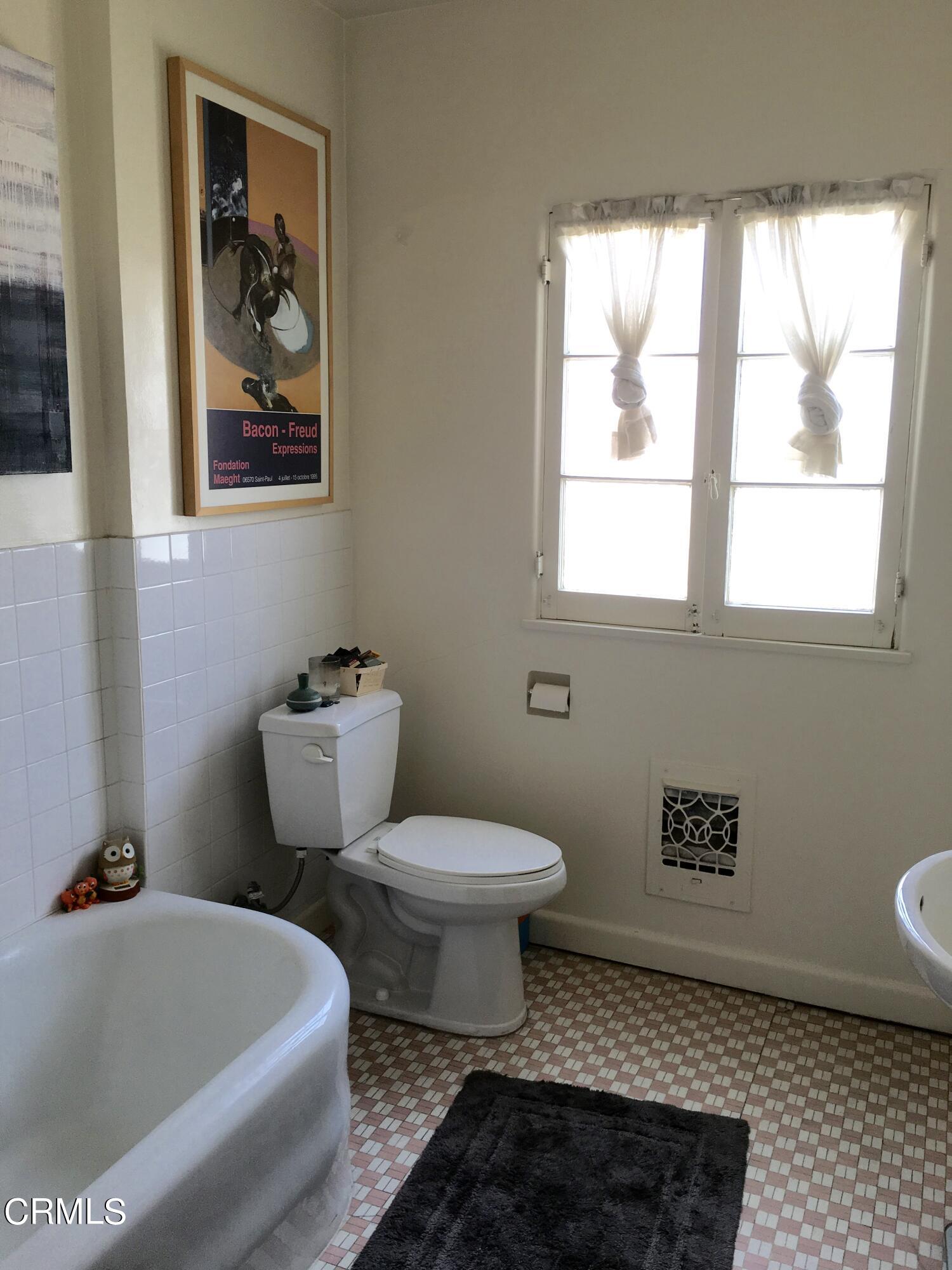 927 Atchison Street Pasadena, CA 91104 - Photo 7 of 13 a bathroom with a toilet a sink and a bathtub