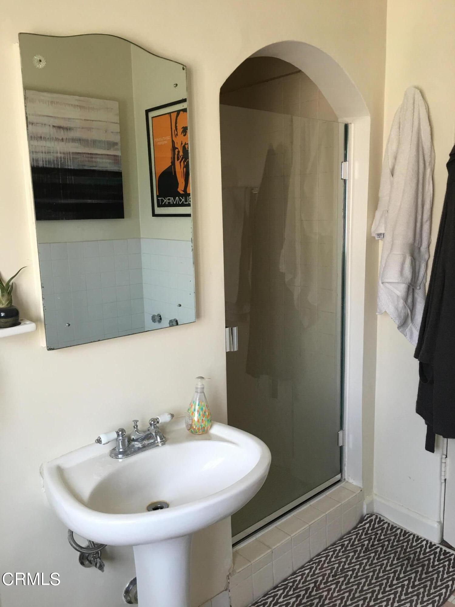 927 Atchison Street Pasadena, CA 91104 - Photo 8 of 13 a bathroom with a sink and a mirror