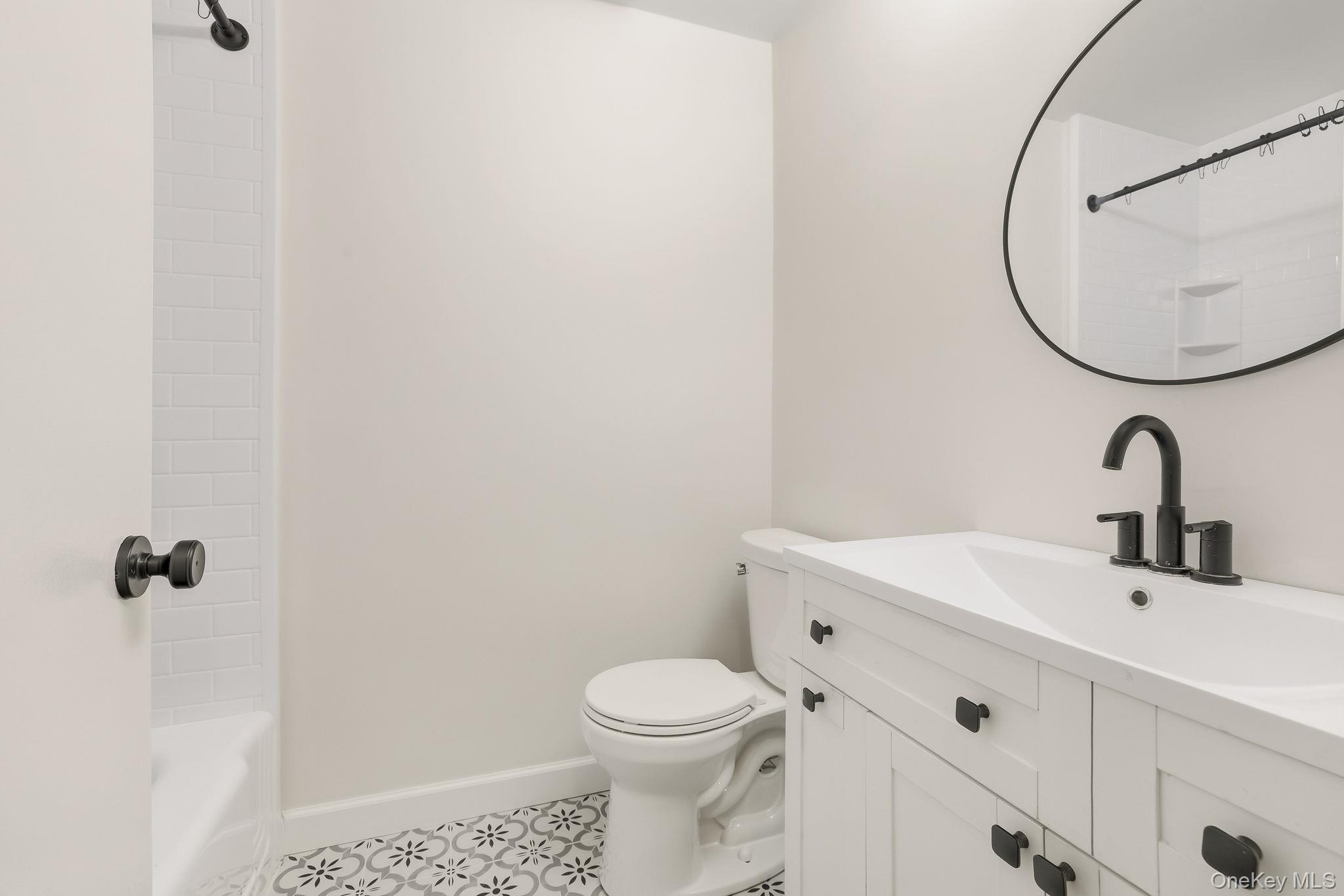 150 Bedford Road, Unit 12A Chappaqua, NY 10514 - Photo 14 of 17 a bathroom with a sink a toilet and a mirror