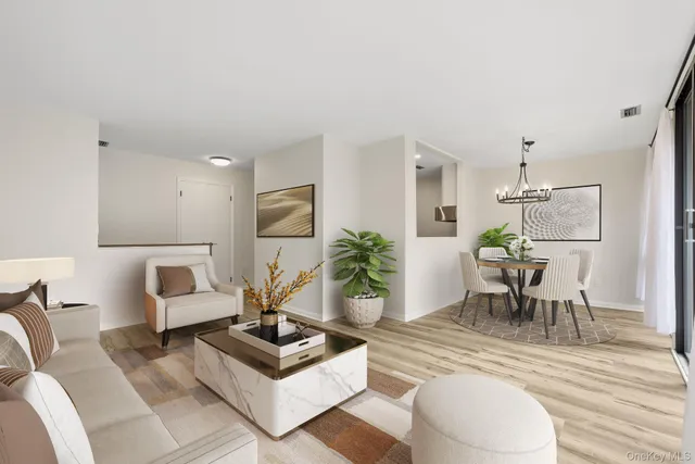 a living room with furniture potted plant and white walls