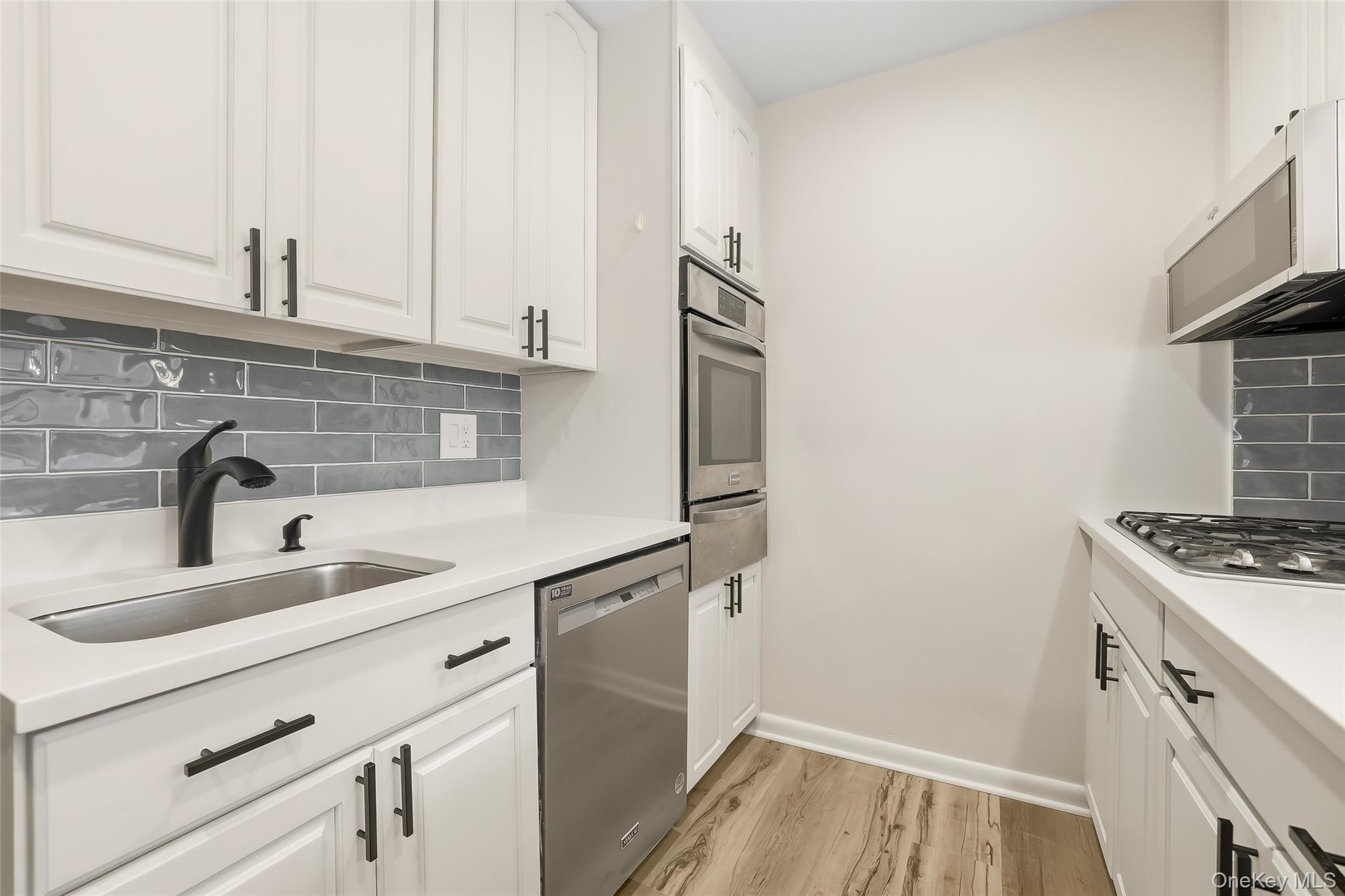 150 Bedford Road, Unit 12A Chappaqua, NY 10514 - Photo 7 of 17 a kitchen with a sink and a stove top oven