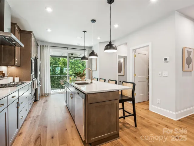 a kitchen with stainless steel appliances kitchen island granite countertop a sink and cabinets