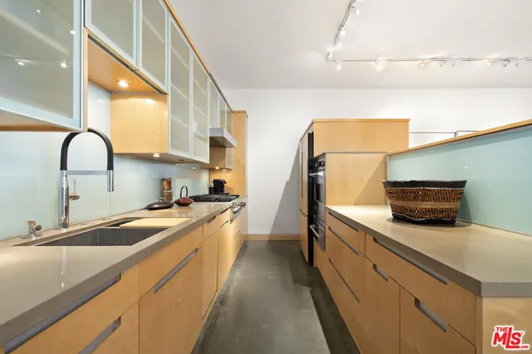 a kitchen with a sink and a refrigerator