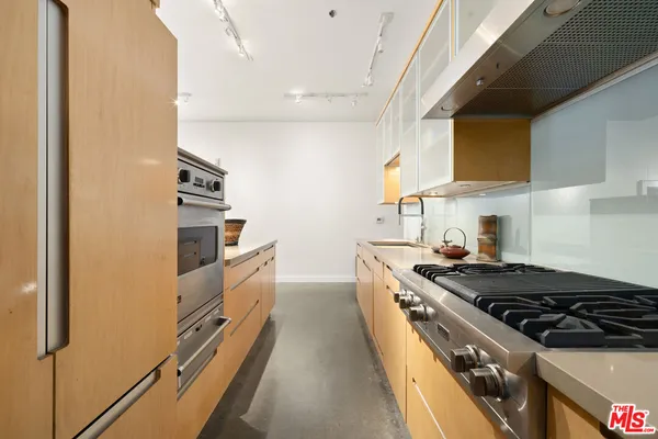 a kitchen with a stove and a refrigerator