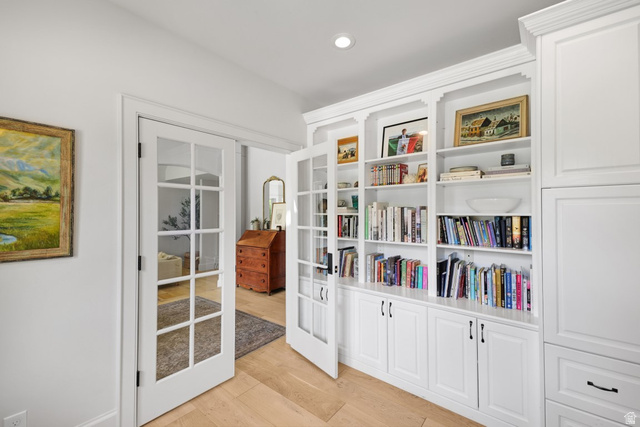 180 Farm Road Midway, UT 84049 - Photo 27 of 99 Built-in shelving with crown molding, white cabinetry with black hardware, wood-finish flooring, and French doors