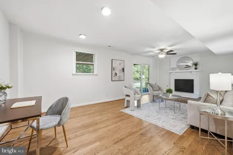 an empty room with wooden floor closet and windows