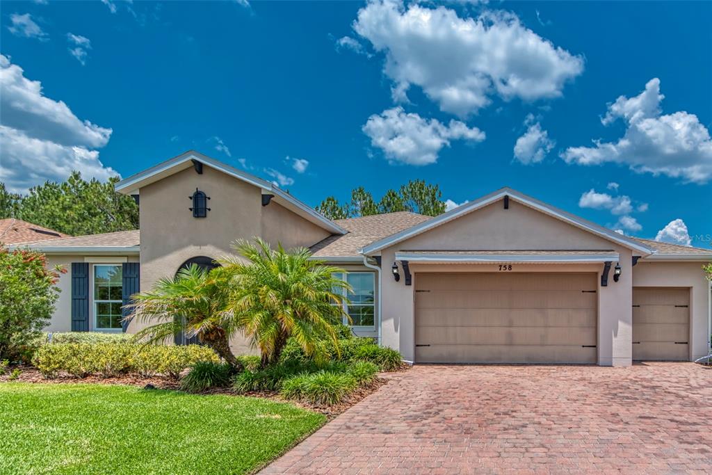 758 Irvine Ranch Road Poinciana, FL 34759 - Photo 1 of 1 a front view of a house with a garden and yard