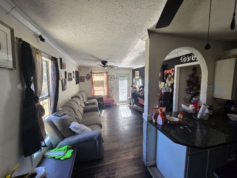 3530 Crow Road Memphis, TN 38108 - Photo 3 of 11 Living room featuring dark hardwood / wood-style floors, ceiling fan, crown molding, and a textured ceiling