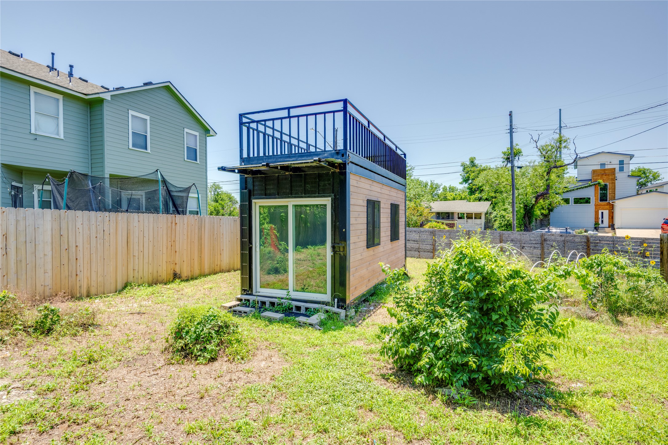 1707 Overhill Drive Austin, TX 78721 - Photo 28 of 36 An innovative accessory dwelling unit, crafted from a container, offers versatile living with a rooftop deck.