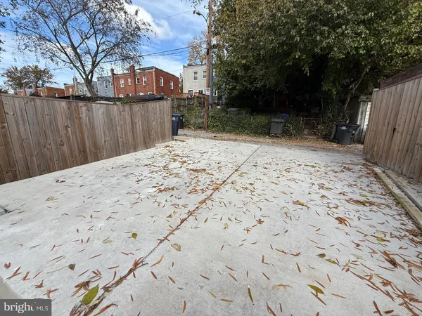 a view of a backyard with a large tree