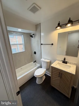 a bathroom with a sink toilet and tub
