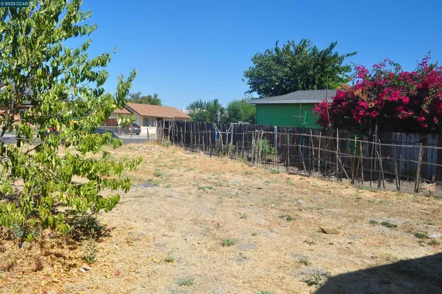 a backyard of a house with lots of green space and fountain