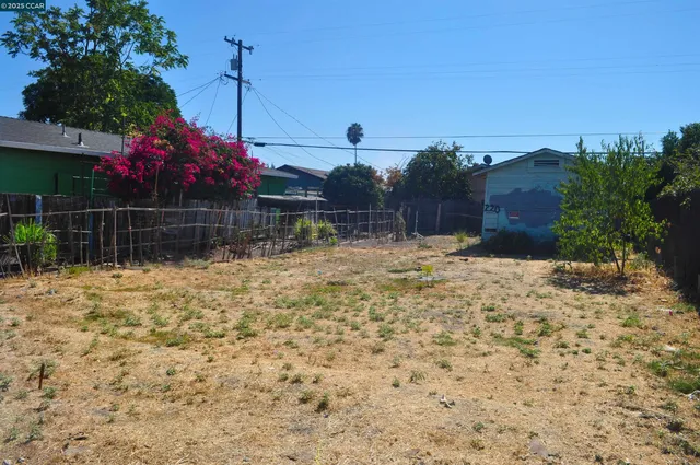 a view of yard with swimming pool and green space