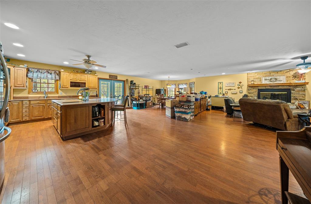 732 Carl Wilson Road Fort White, FL 32038 - Photo 10 of 80 a living room with stainless steel appliances kitchen island granite countertop a stove top oven a dining table and chairs with wooden floor