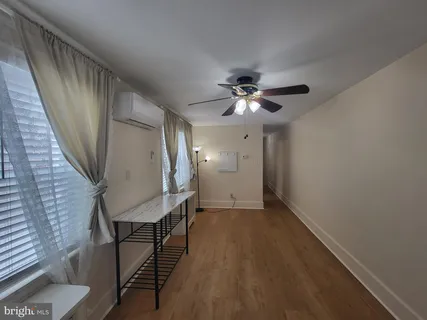 a view of a livingroom with furniture and chandelier fan