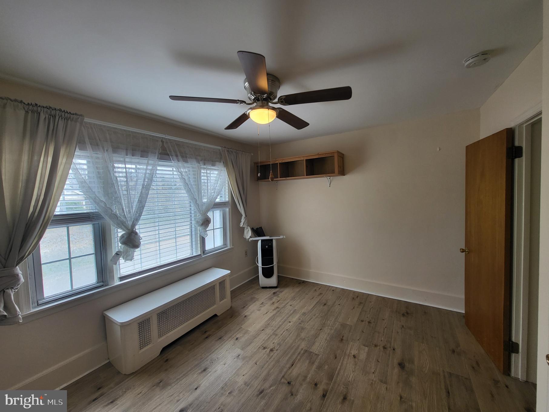 2122 Darby Road Havertown, PA 19083 - Photo 3 of 15 wooden floor in an empty room with a window