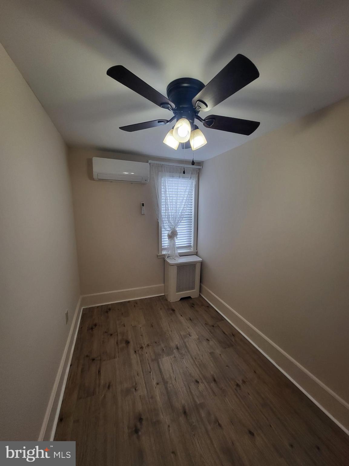 2122 Darby Road Havertown, PA 19083 - Photo 4 of 15 en empty room with wooden floor and a ceiling fan
