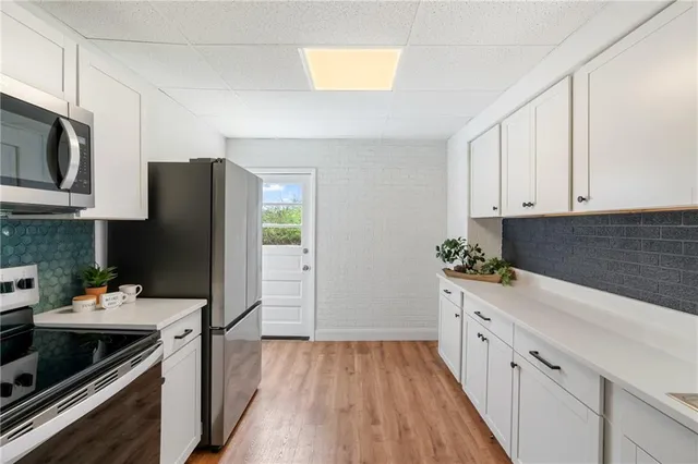 a kitchen with a sink stove and refrigerator