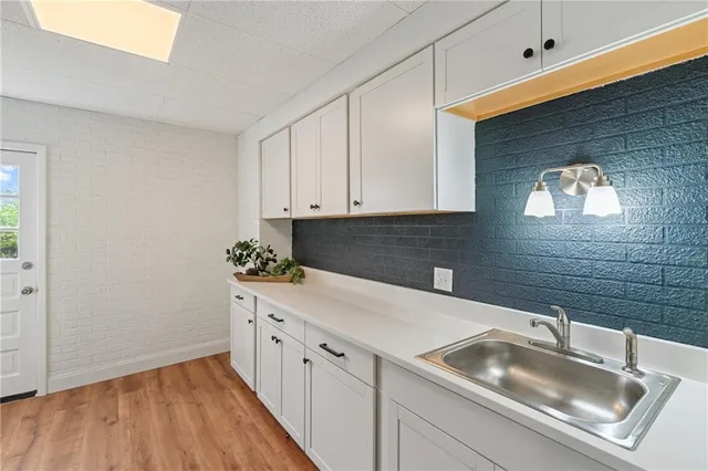 a kitchen with a sink and cabinets