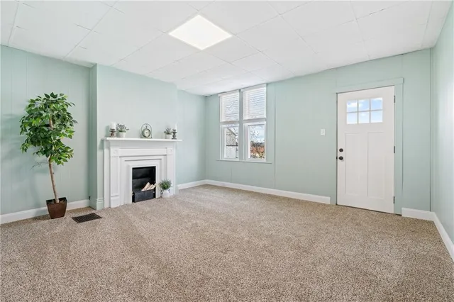 a view of empty room with a fireplace