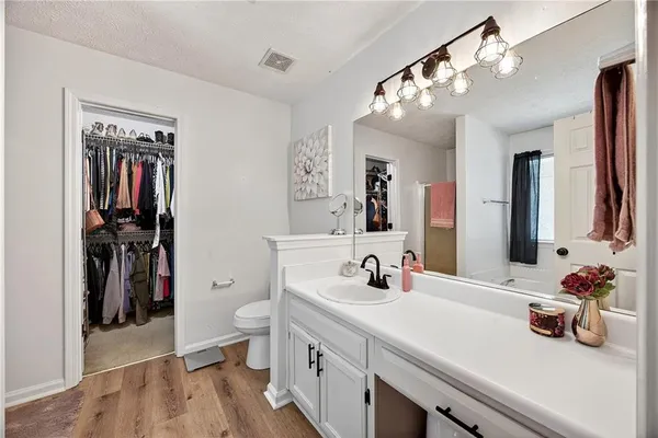 a bathroom with a double vanity sink mirror and toilet