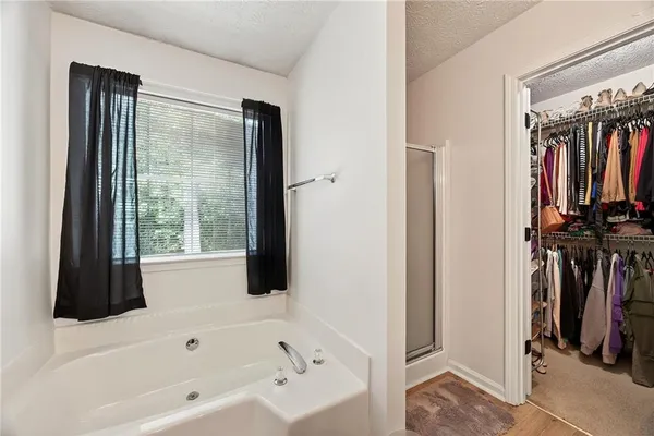a bathroom with a bathtub and a shower
