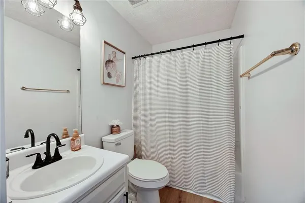 a bathroom with a sink a toilet and a mirror