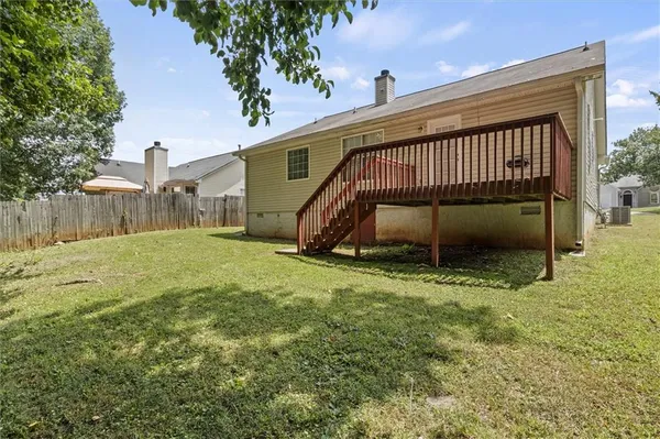 a view of backyard with a garden and deck