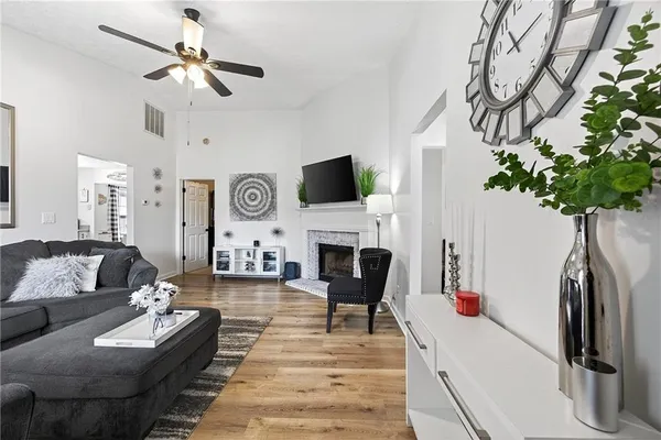 a living room with furniture a fireplace and a flat screen tv