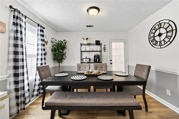 a view of a dining room with furniture and wooden floor