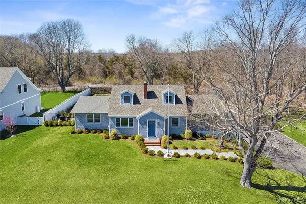 a view of a house with garden and trees