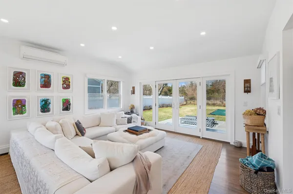 a living room with furniture and large window with garden view