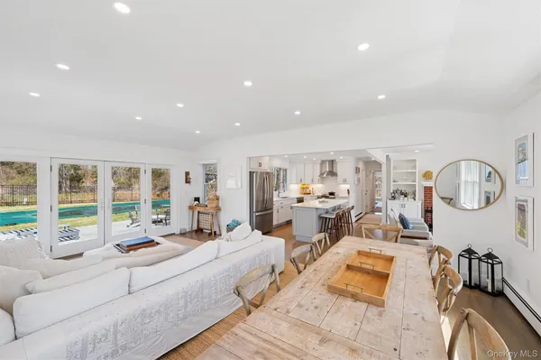 a living room with furniture floor to ceiling window and rug