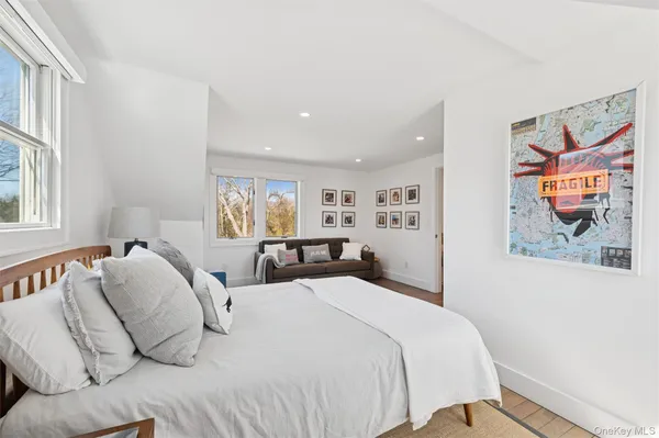 a bedroom with a bed and glass windows