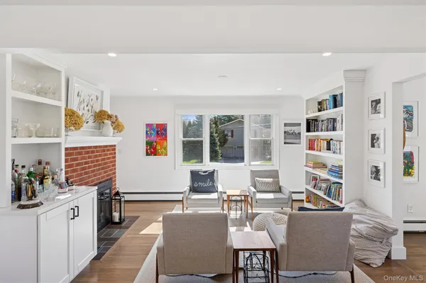 a living room with furniture a rug and a window