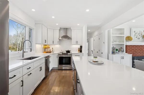 a kitchen with white cabinets and appliances