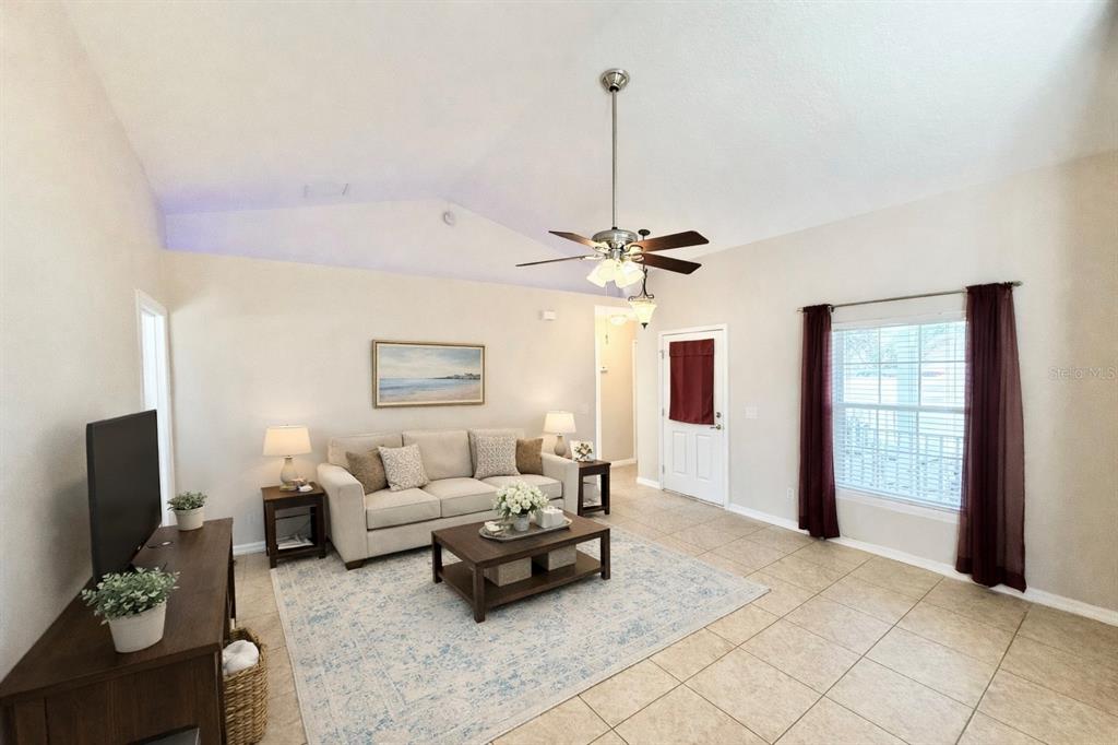 1220 Myrtle Avenue St. Cloud, FL 34771 - Photo 12 of 59 a living room with furniture and a flat screen tv