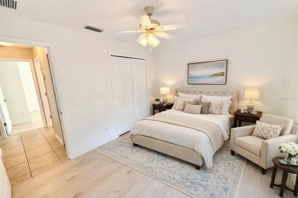 1220 Myrtle Avenue St. Cloud, FL 34771 - Photo 13 of 59 a bedroom with a bed and a chandelier