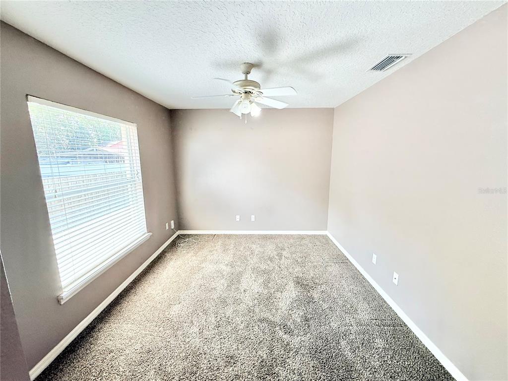 1220 Myrtle Avenue St. Cloud, FL 34771 - Photo 17 of 59 an empty room with a window and a ceiling fan